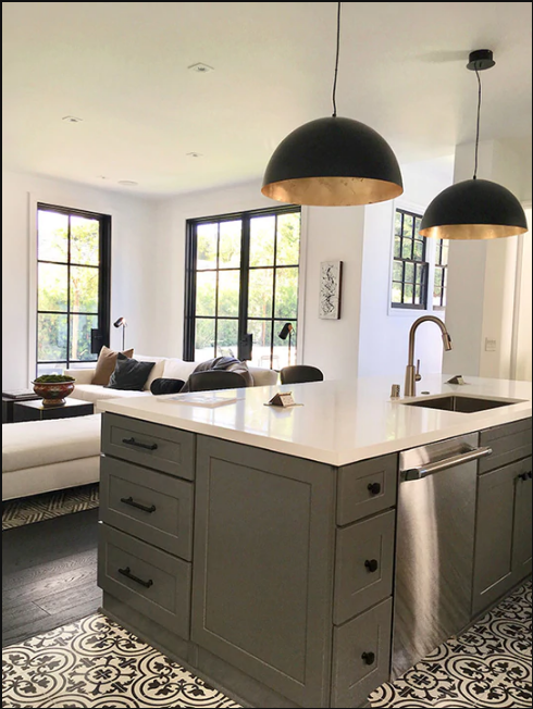 a kitchen with big iron windows