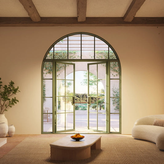 Arched glass doors open to a sunny patio with greenery, viewed from a cozy living room with rustic beams.