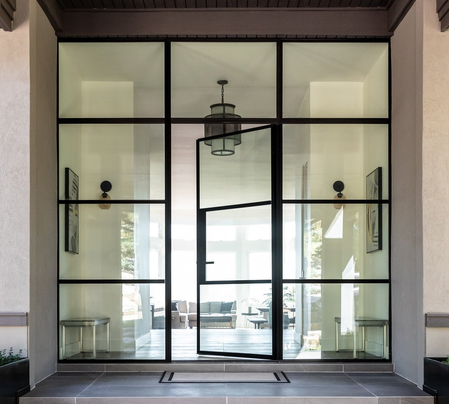 Contemporary steel front door with minimalist steel frame and glass insert