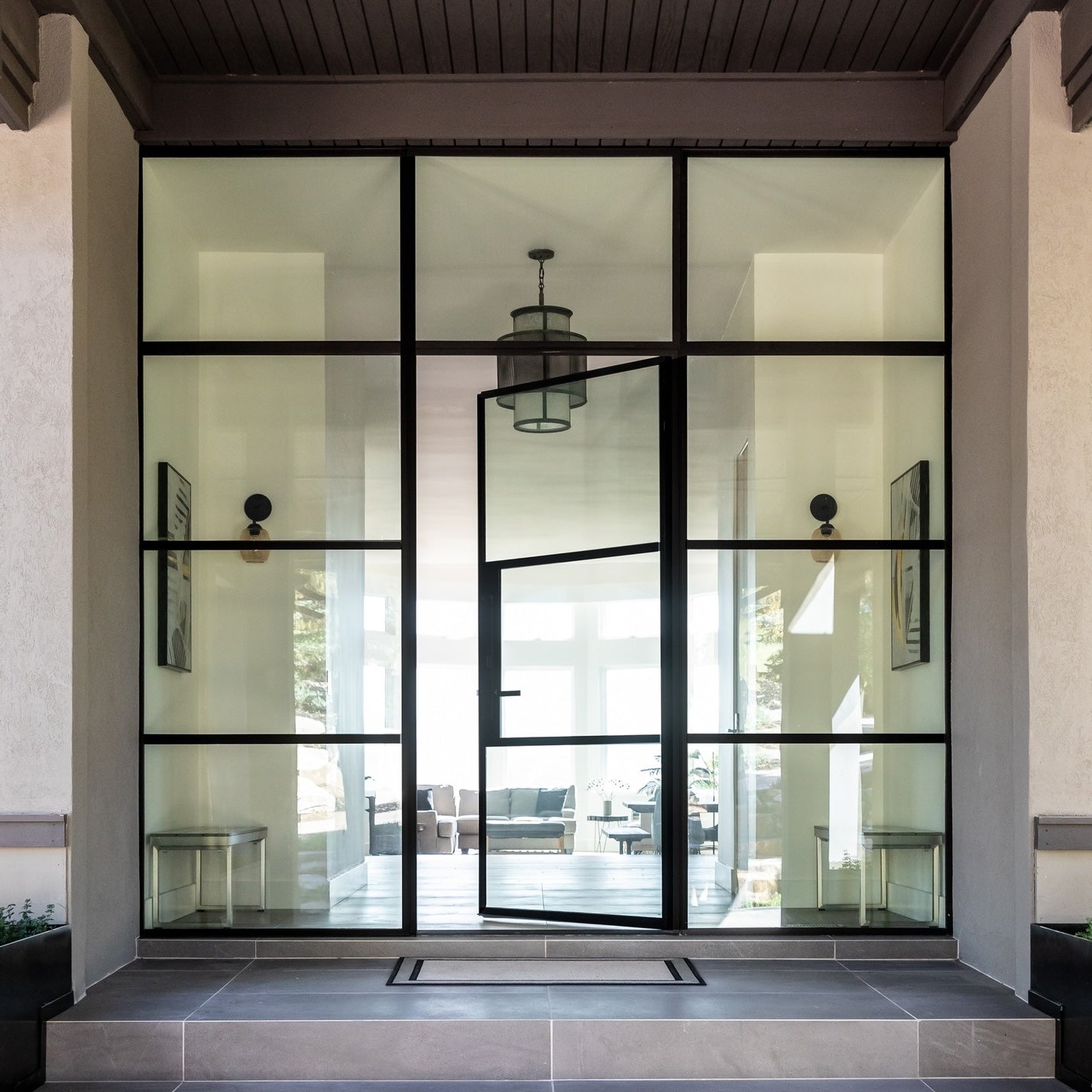 Contemporary steel front door with minimalist steel frame and glass insert
