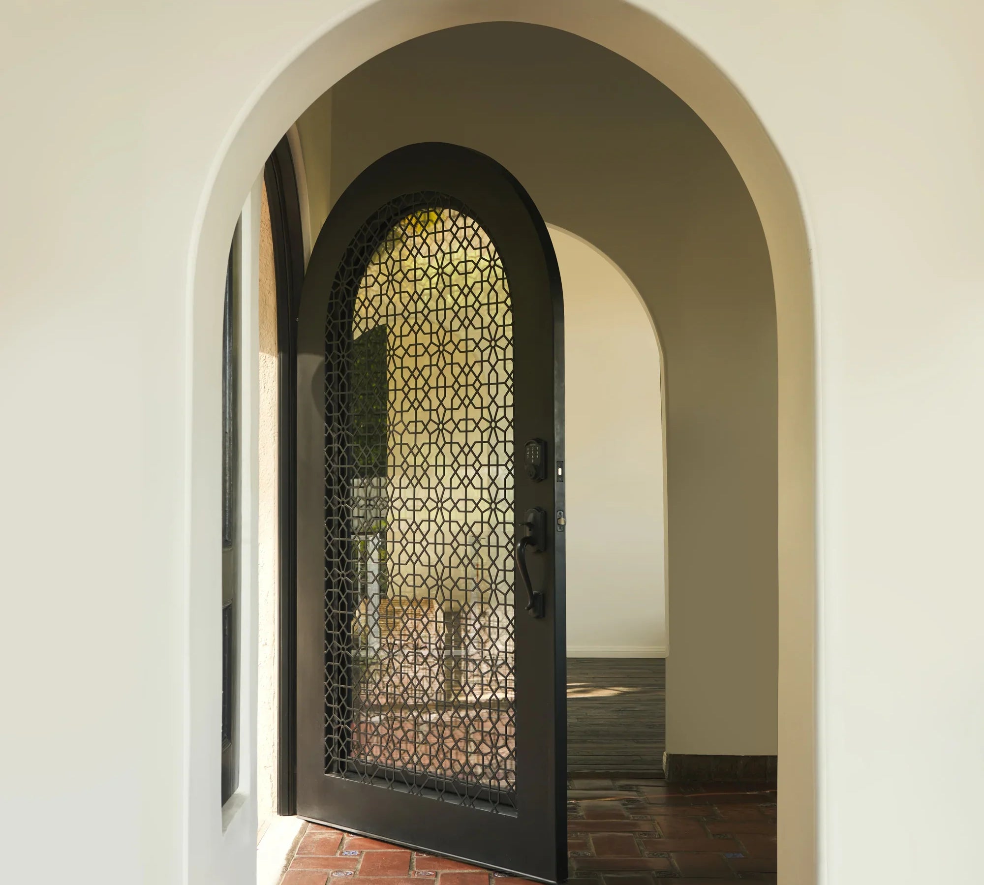 spanish-inspired classic iron full arch top entry door
