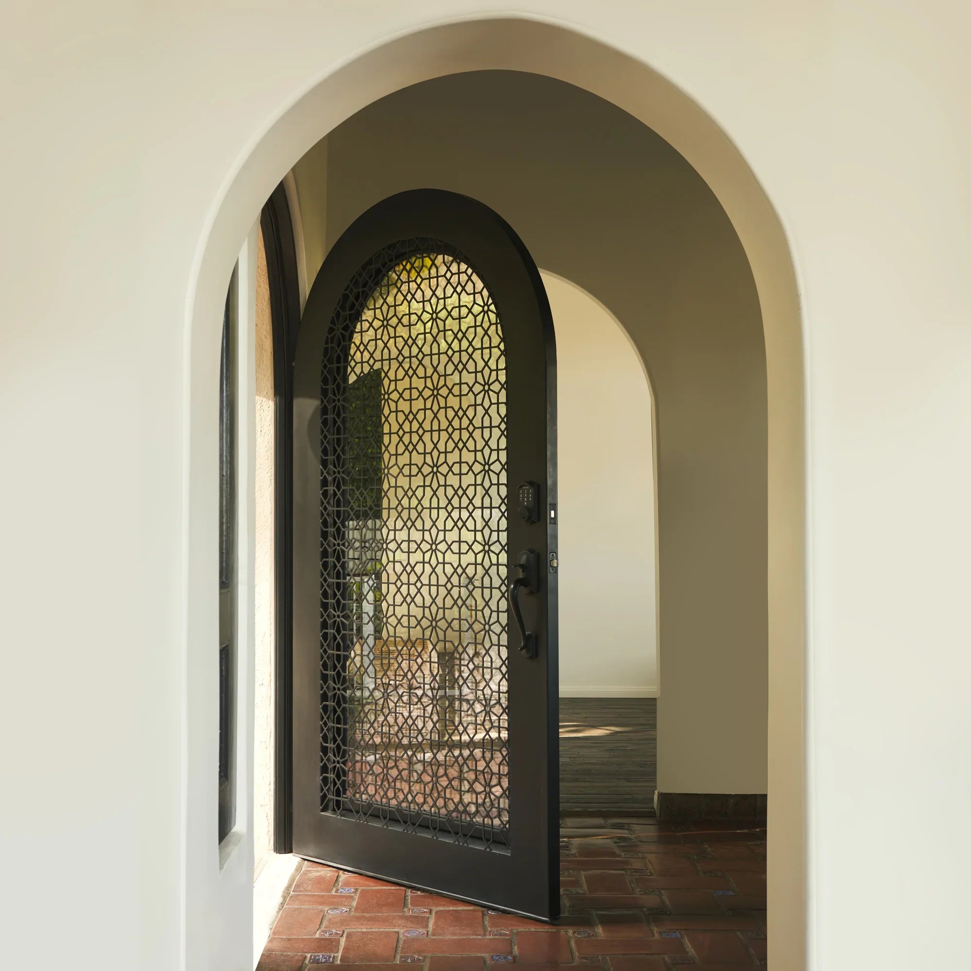 spanish-inspired classic iron full arch top entry door