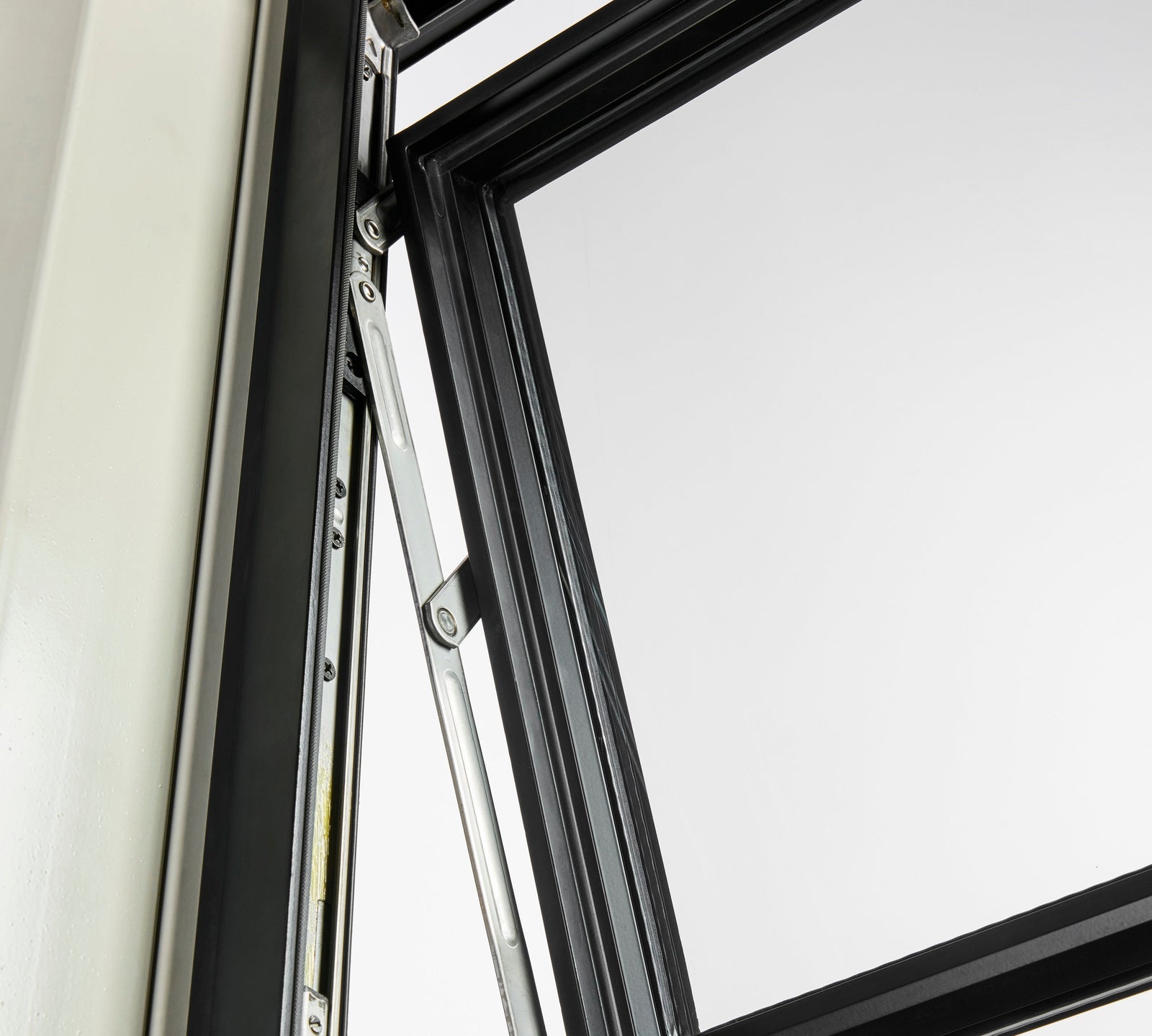 Top-hinged steel awning window open outward for ventilation with clean sightlines