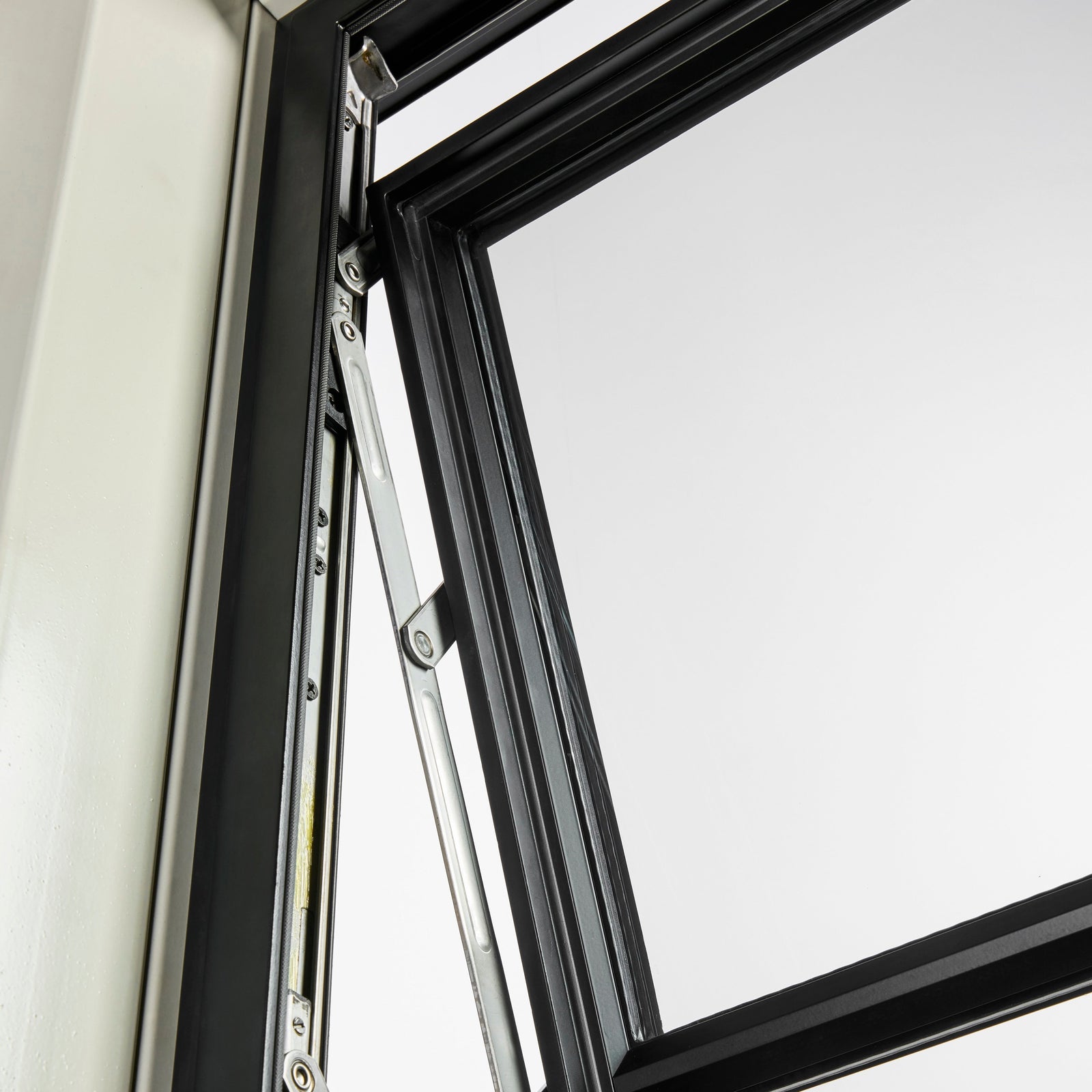 Top-hinged steel awning window open outward for ventilation with clean sightlines