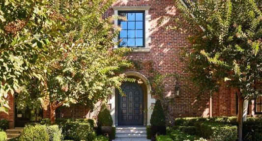 a beautiful entryway with wrought iron doors