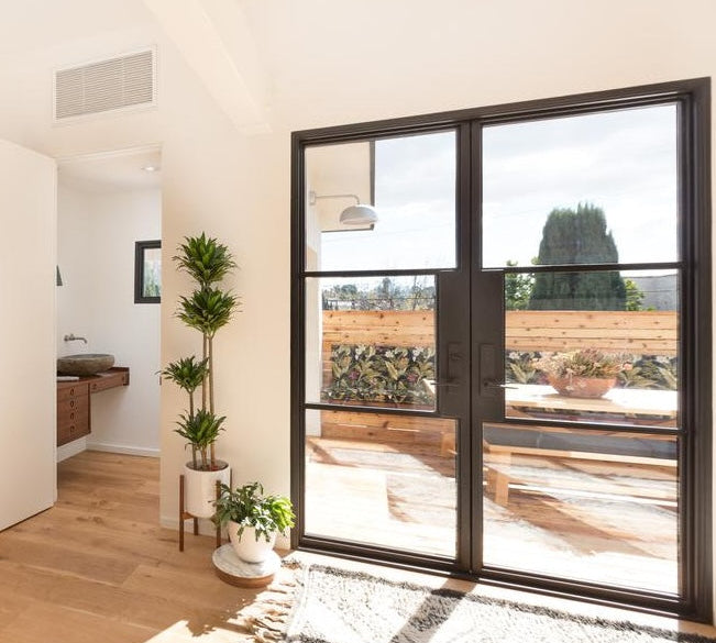 Double steel front door with clear glazing and sleek architectural frame
