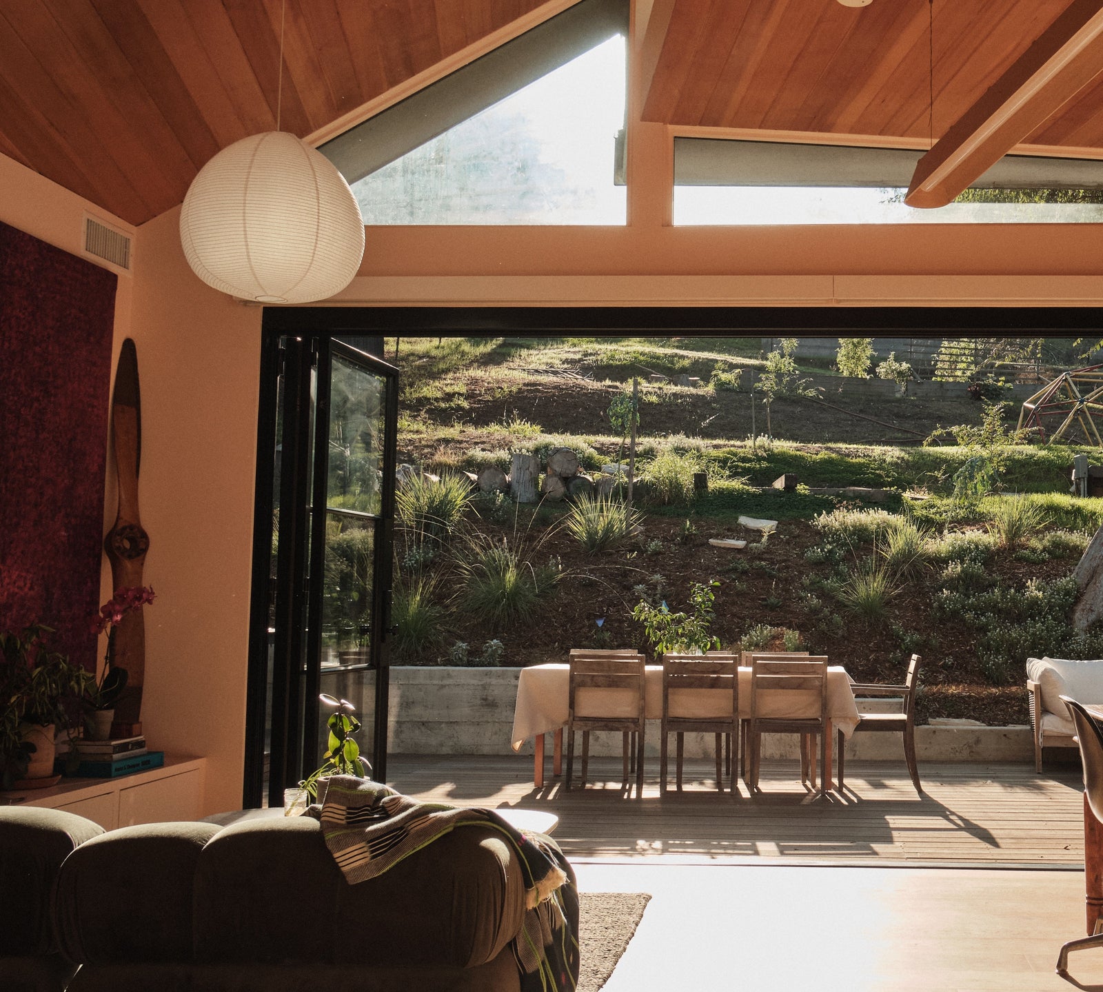 Modern bi-fold steel patio door with clear glass panels and slim frame