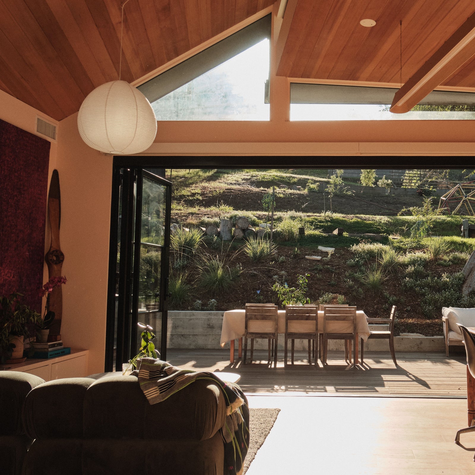 Modern bi-fold steel patio door with clear glass panels and slim frame