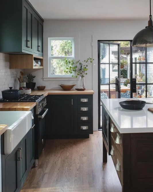 A room interior with wooden floors and black steel doors.