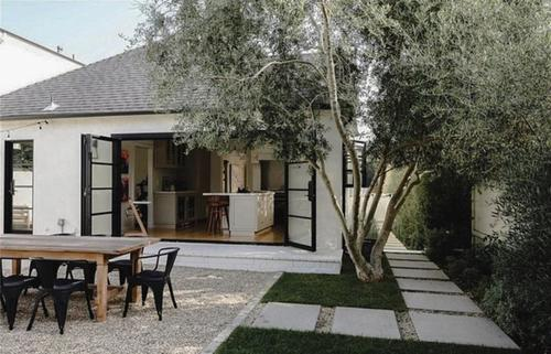 patio with wooden table and iron doors