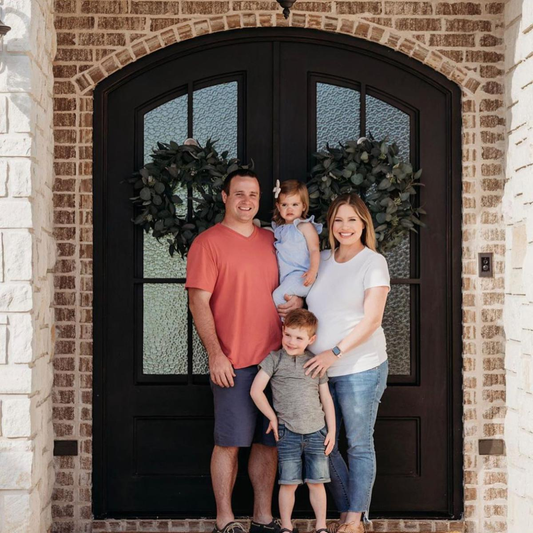  A family standing in front of a French door