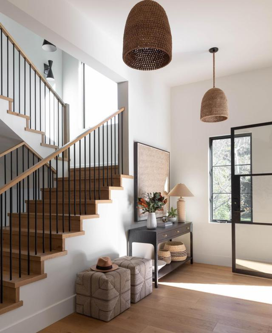 A room with brown wooden floors and black steel doors.