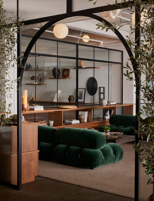 Pinkys arch showroom air grand door framed by olive trees