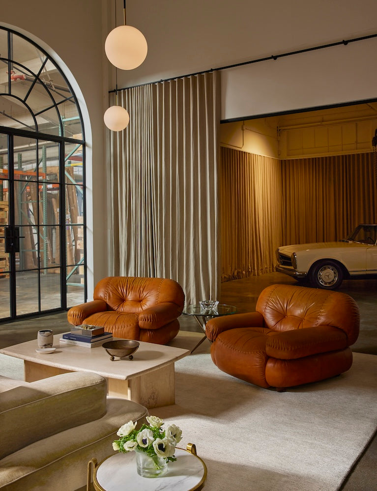 Pinkys showroom with plush leather chairs and nice car