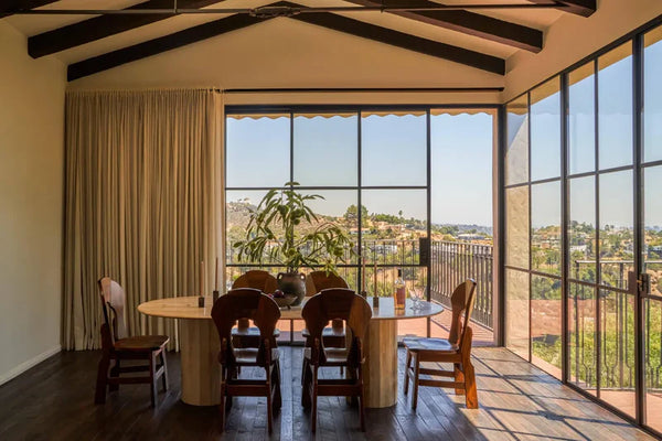 luxury dining room featuring black steel sliding and french doors with ultra-slim sightlines
