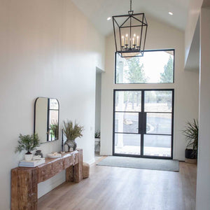 Flat top transom over steel doors in bright entry hall