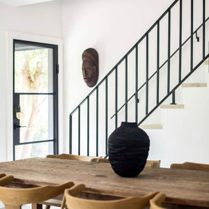 Bright dining room with single steel door and staircase