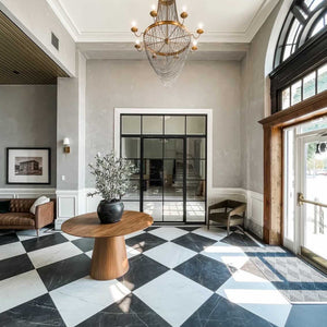 A richly appointed lobby featuring steel interior doors with side windows and transom