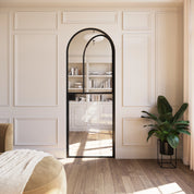 Solid steel Dutch door with full arch top and modular construction.