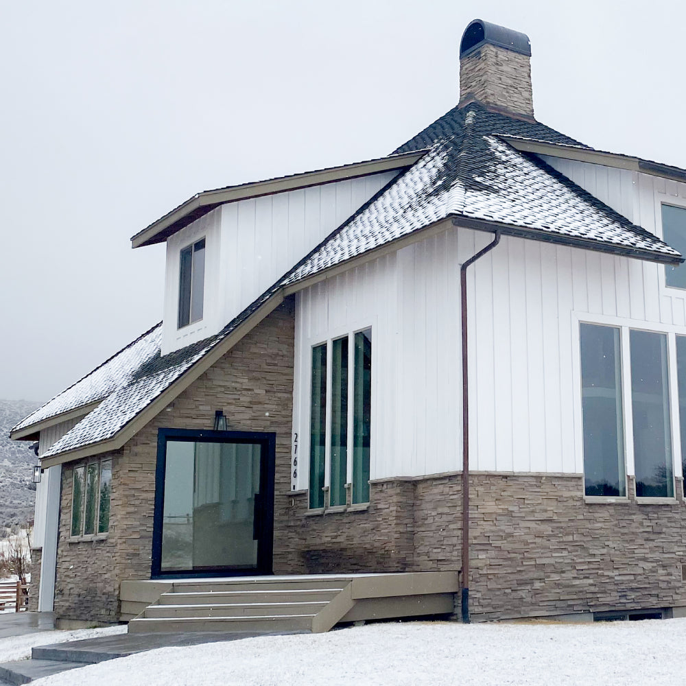 Large open pivot door on spacious house in the snow