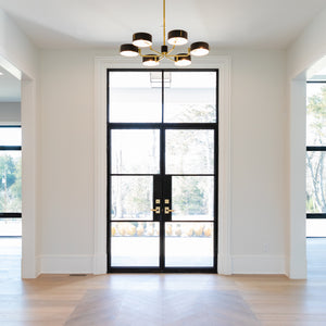 Airy entryway featuring double steel doors with a flat top window