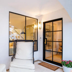 A cozy porch in the early evening with warm window and steel single door