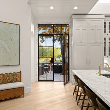 Load image into Gallery viewer, Luxury kitchen mixing modern and classic designs featuring steel doors with flat top transom on shady patio