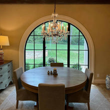 Load image into Gallery viewer, Dining room featuring single full arch door with side windows