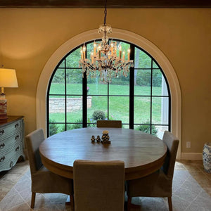 Dining room featuring single full arch door with side windows