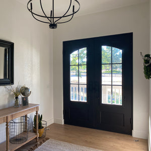 Airy entry hall fronted with a pair of stylish modern steel front doors