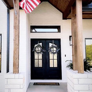 Sleek industrial iron double front doors on a beachside home