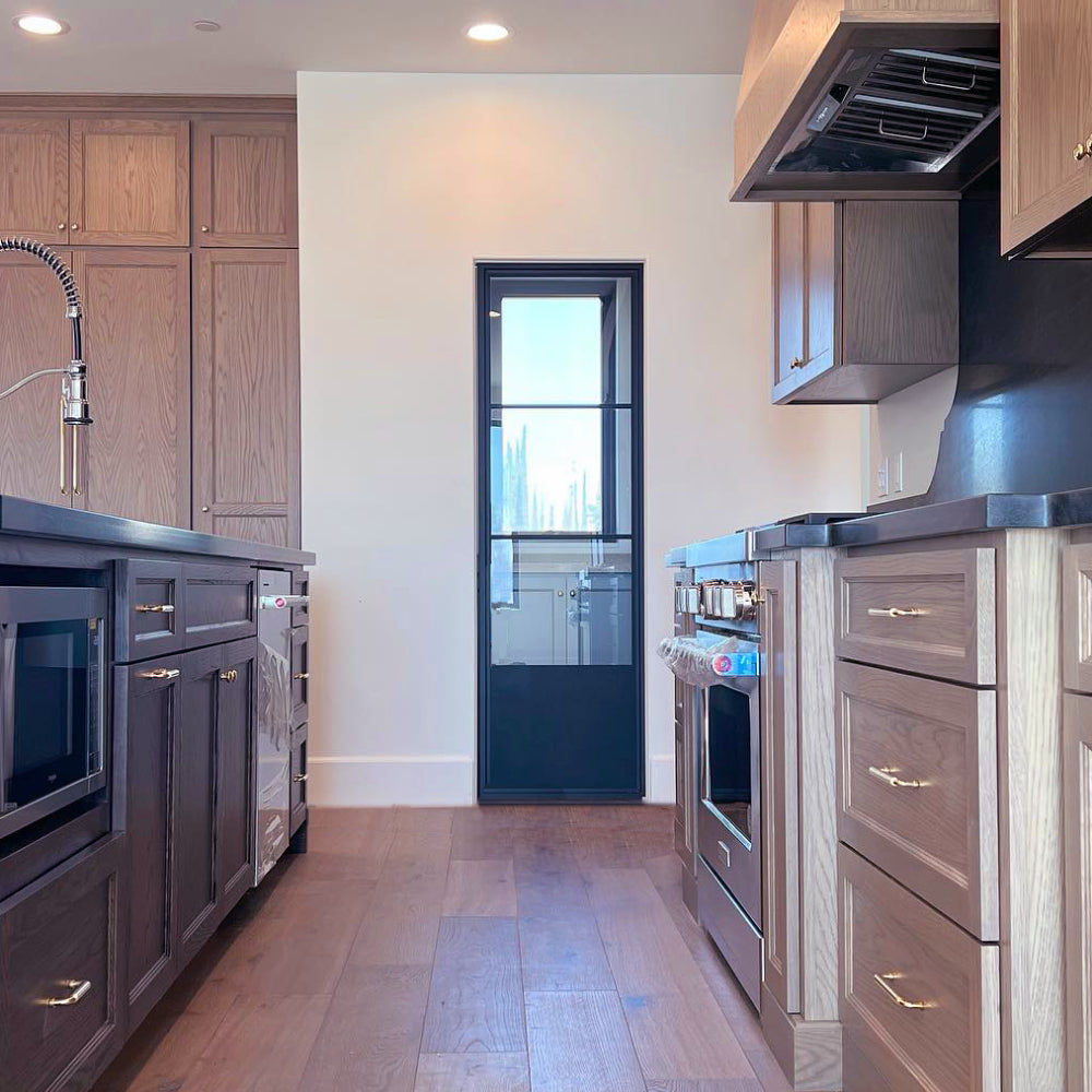 Stylish steel pantry door with kickplate in home kitchen