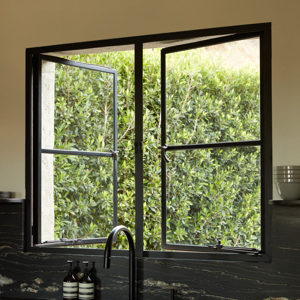 Square double casement window in kitchen over sink