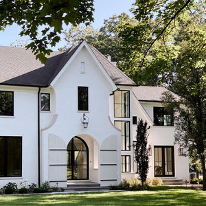 A big white house with fixed windows and glass doors