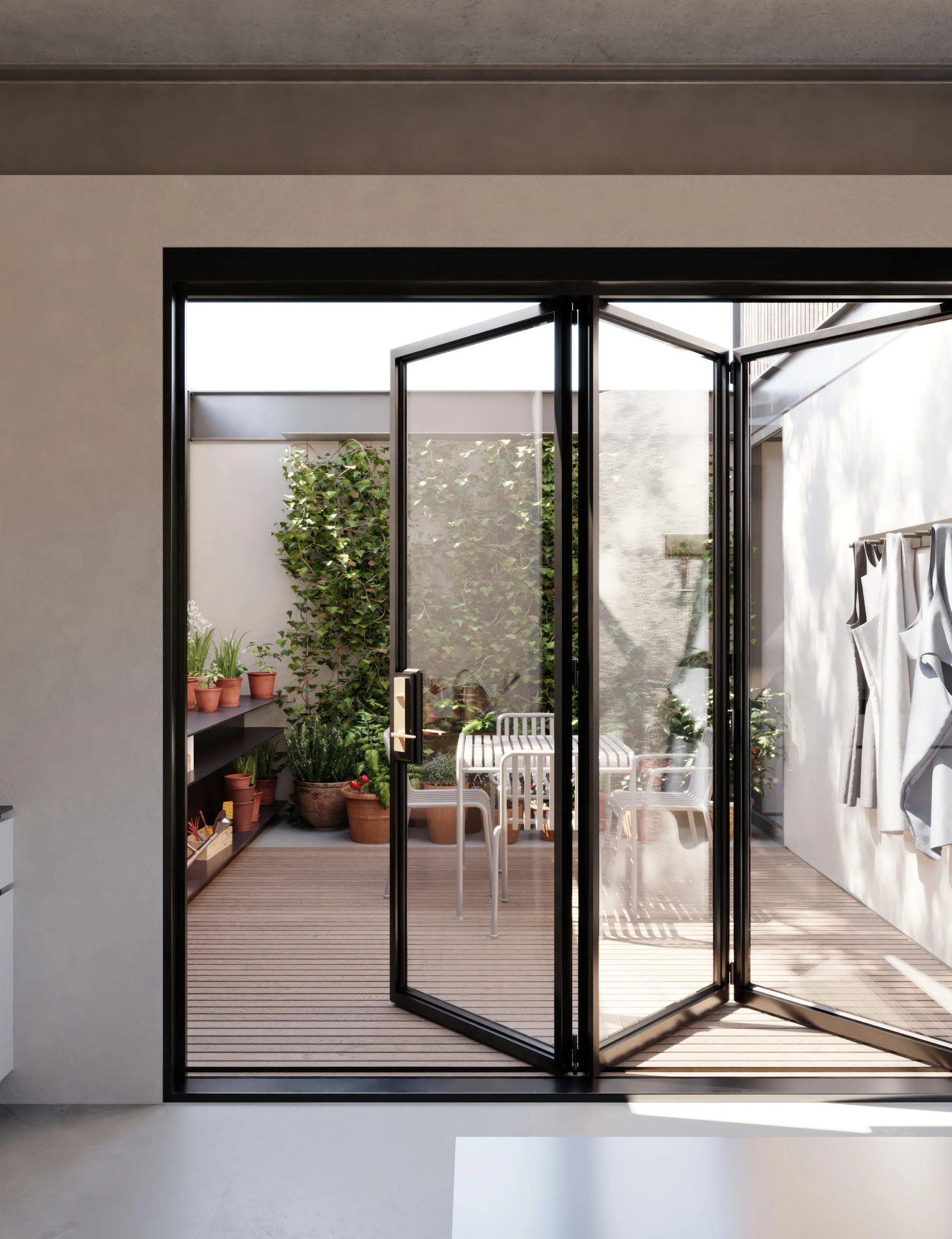Exterior steel bi-fold doors with wide openings and modern profiles.
