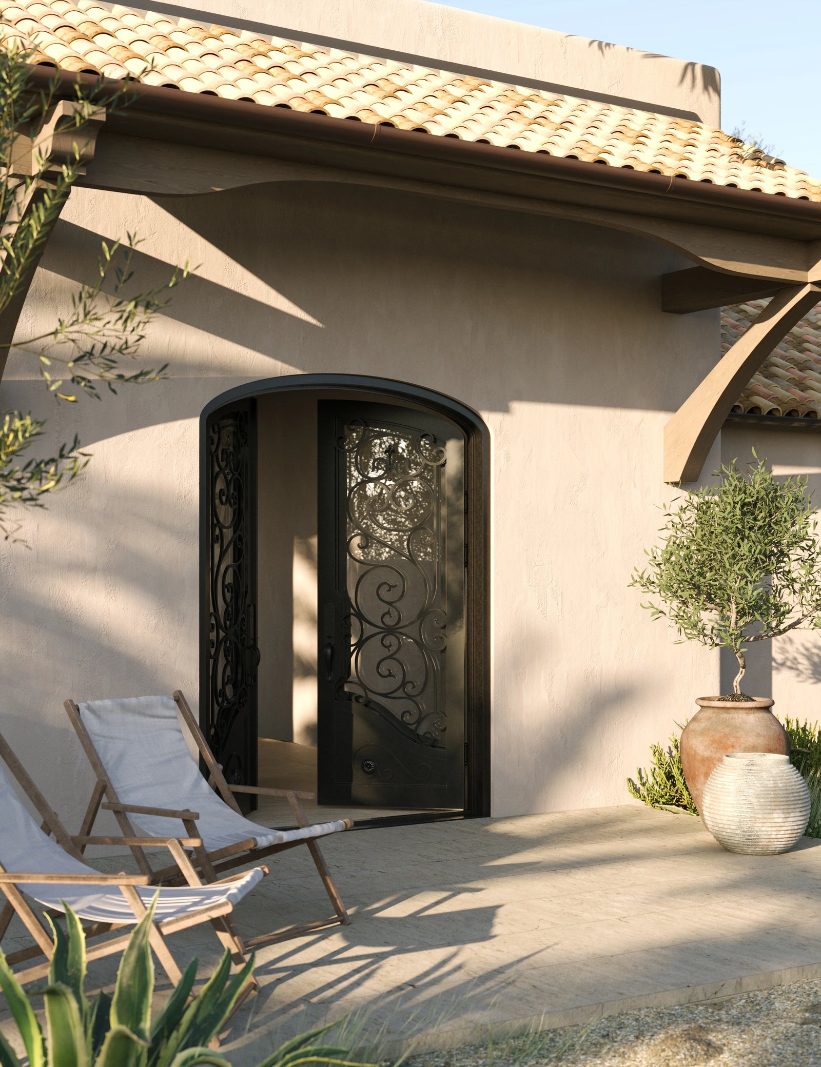 Beverly arched iron entry door with glass in bronze tone.