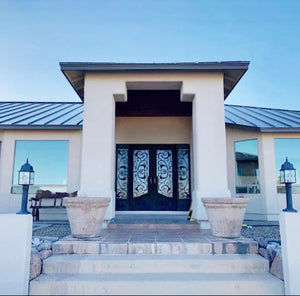 Wrought iron doors with sidelights in a sunny entry