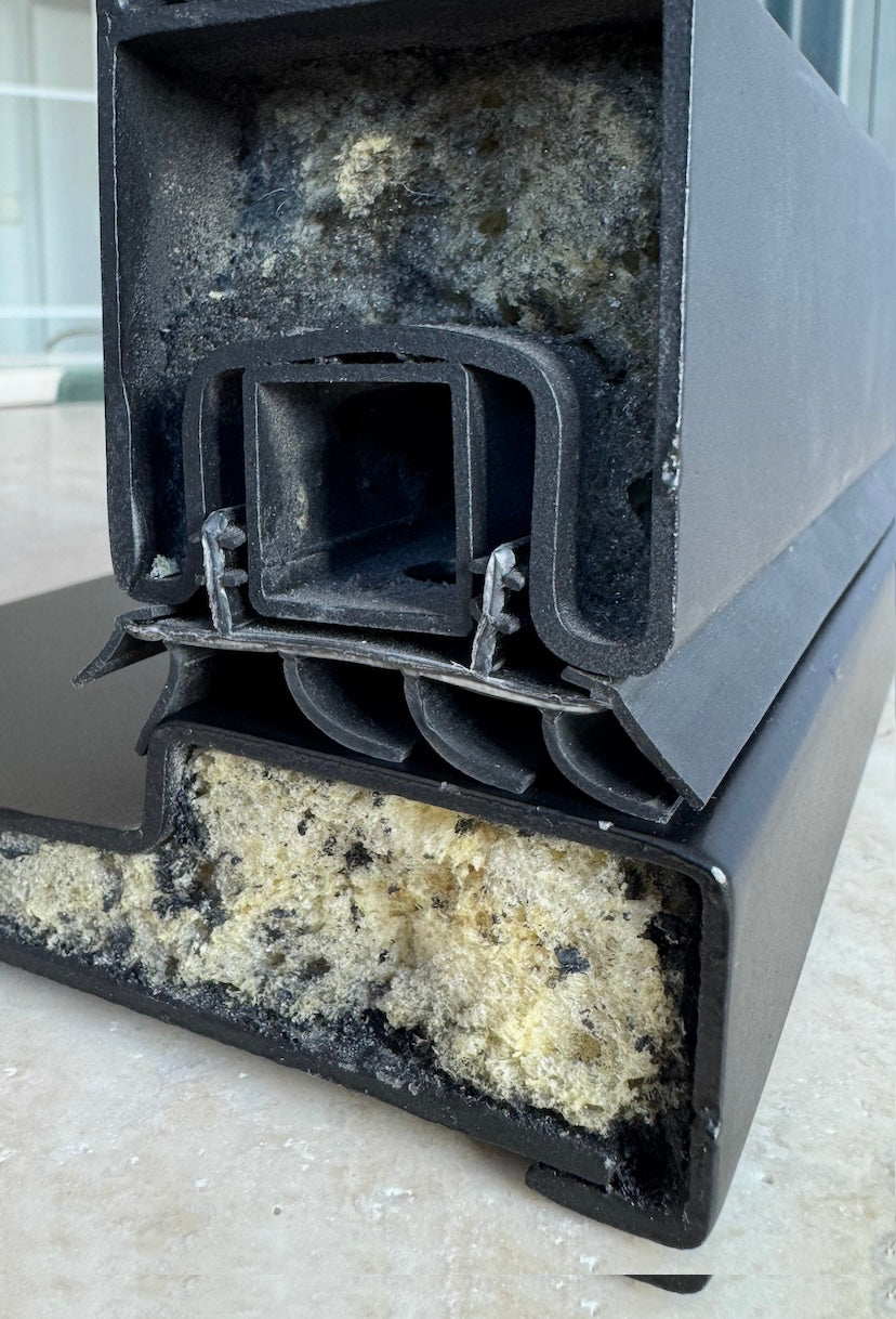 Closeup of unfinished steel door threshold filled with foam