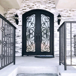 Stylish wrought iron arched double front doors at top of stairs