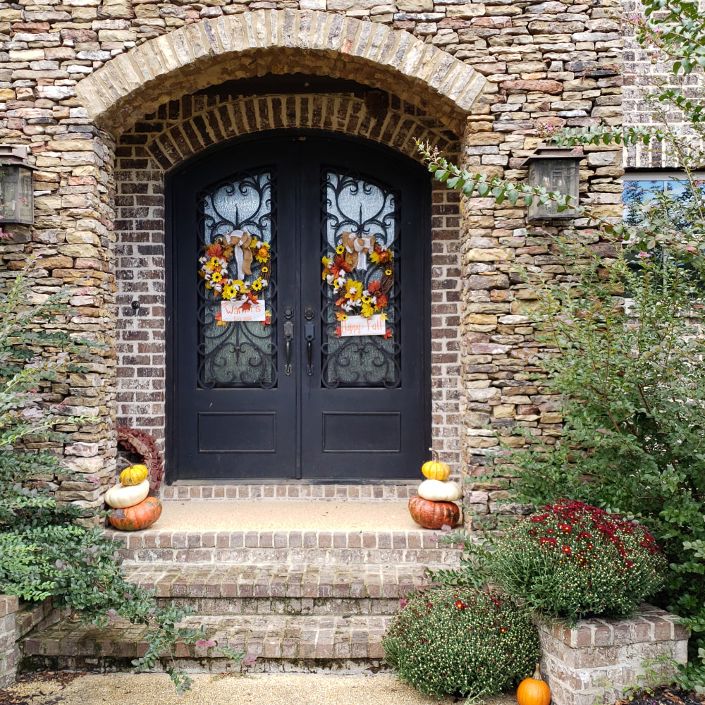 Arched double iron doors in a storybook stone entryway