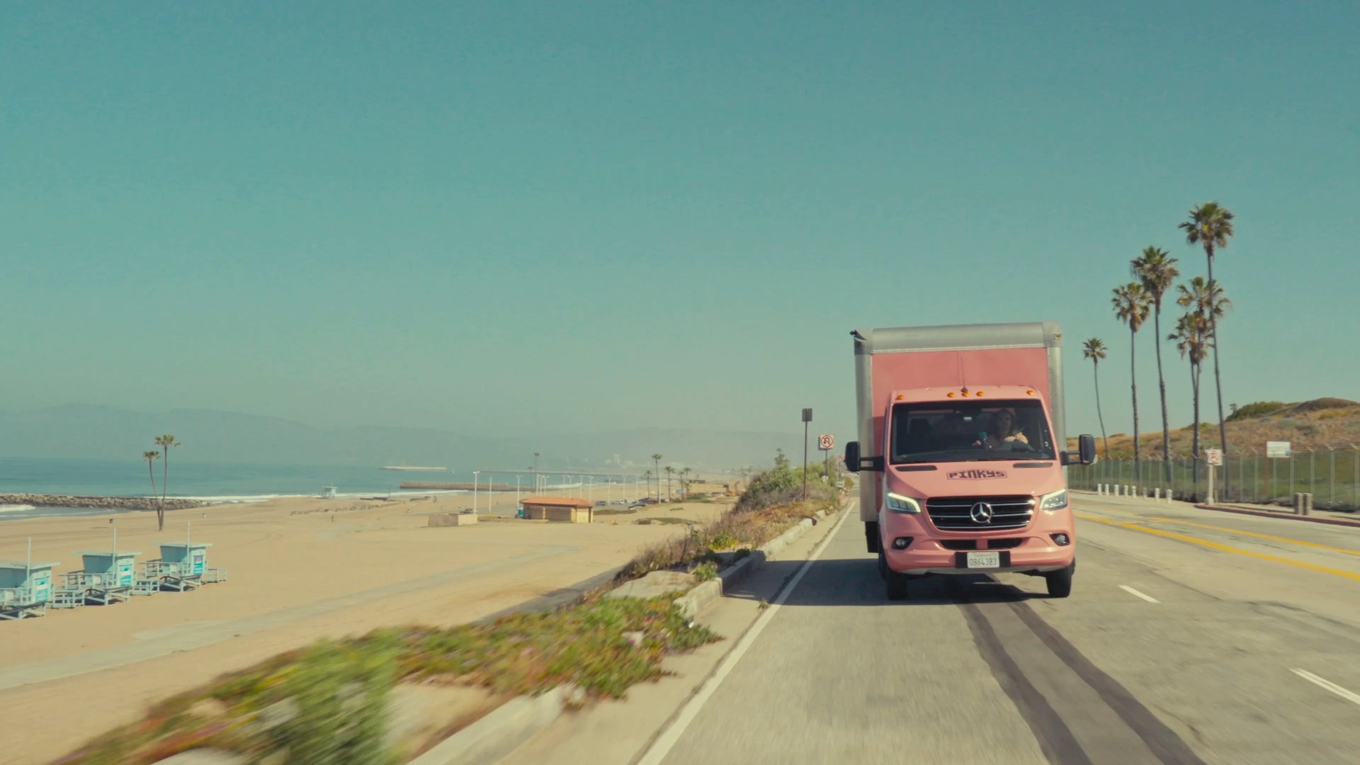 PINKYS' iconic pink delivery truck cruising down the Pacific Coast Highway near Venice Beach