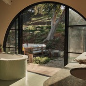 Large-format steel entry door with expansive glass panels and slim architectural steel frame