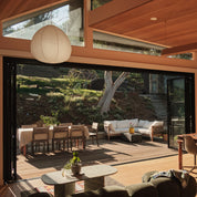 Floor-to-ceiling steel door with large glass panels and modern architectural design