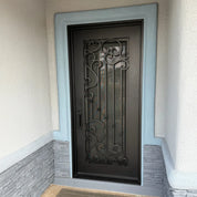 Flat topped iron single door with ornate scrollwork and operable glass
