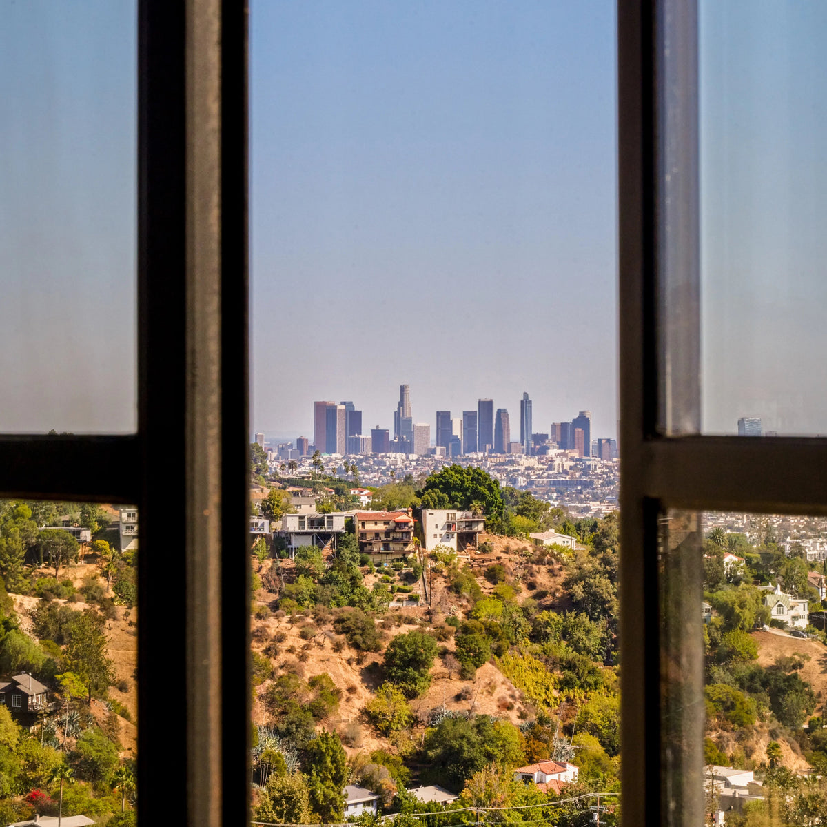 Los Angeles skyline viewed through steel double casement window