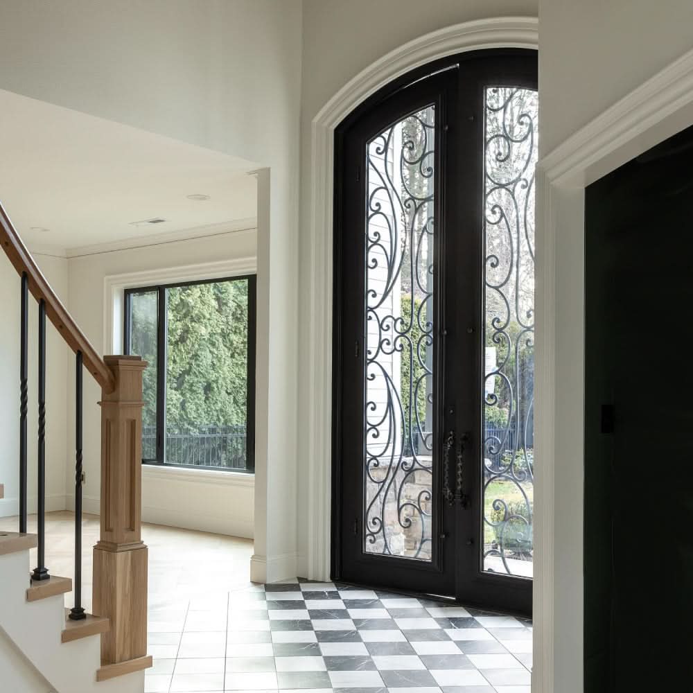 Sunset with Handgrip bronze colored arched top entry door with glass and thermal break.