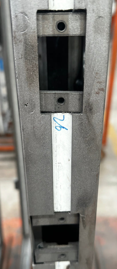 Unfinished thermally broken frame showing holes for strike plates