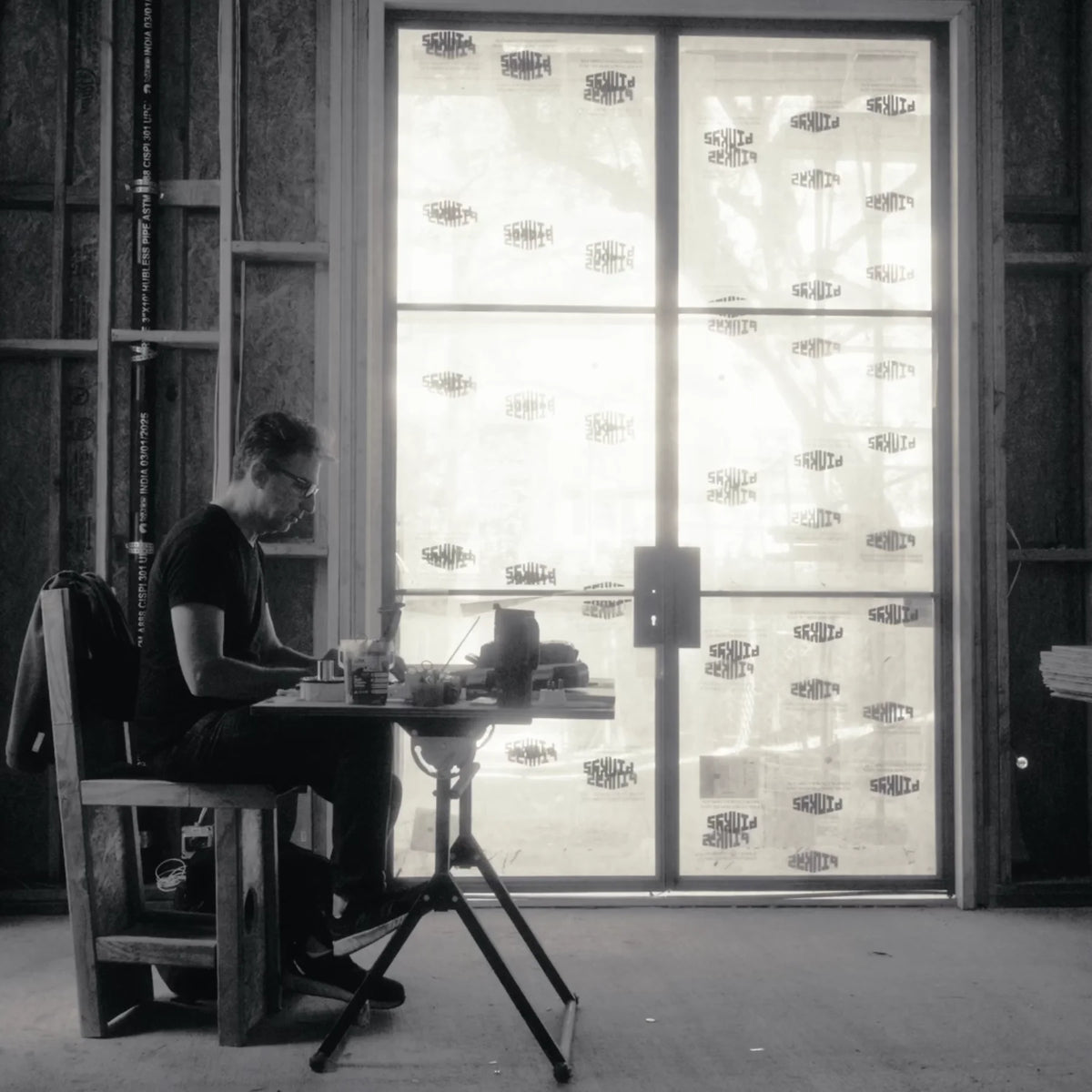 man on jobsite working to plan installation of steel dors