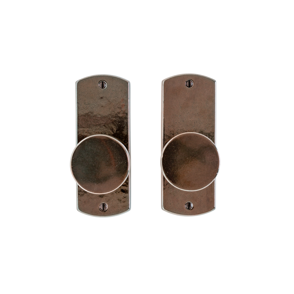 Bronze rocky mountain curved passage handle with living finish.