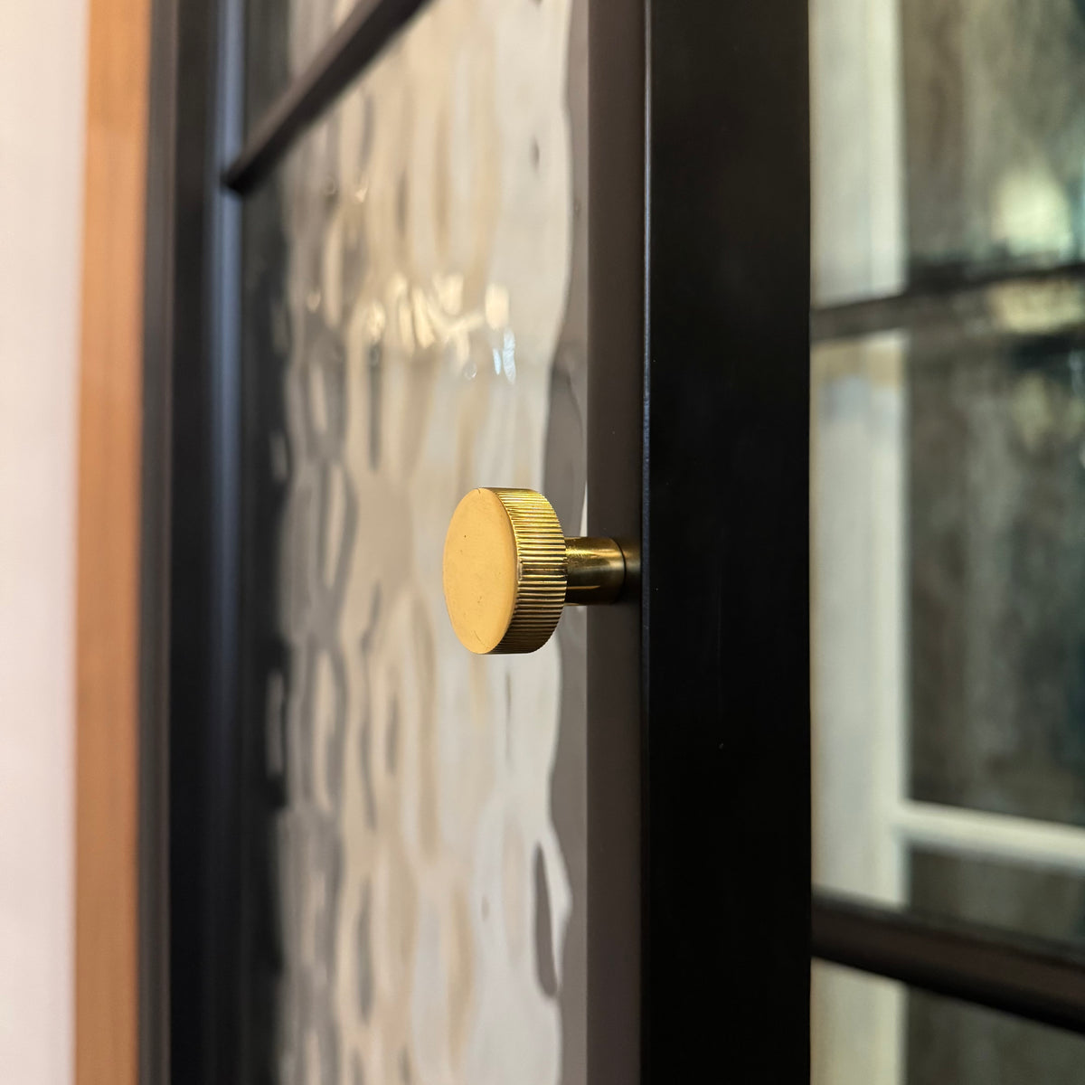 double black steel interior pantry door with round pull hardware